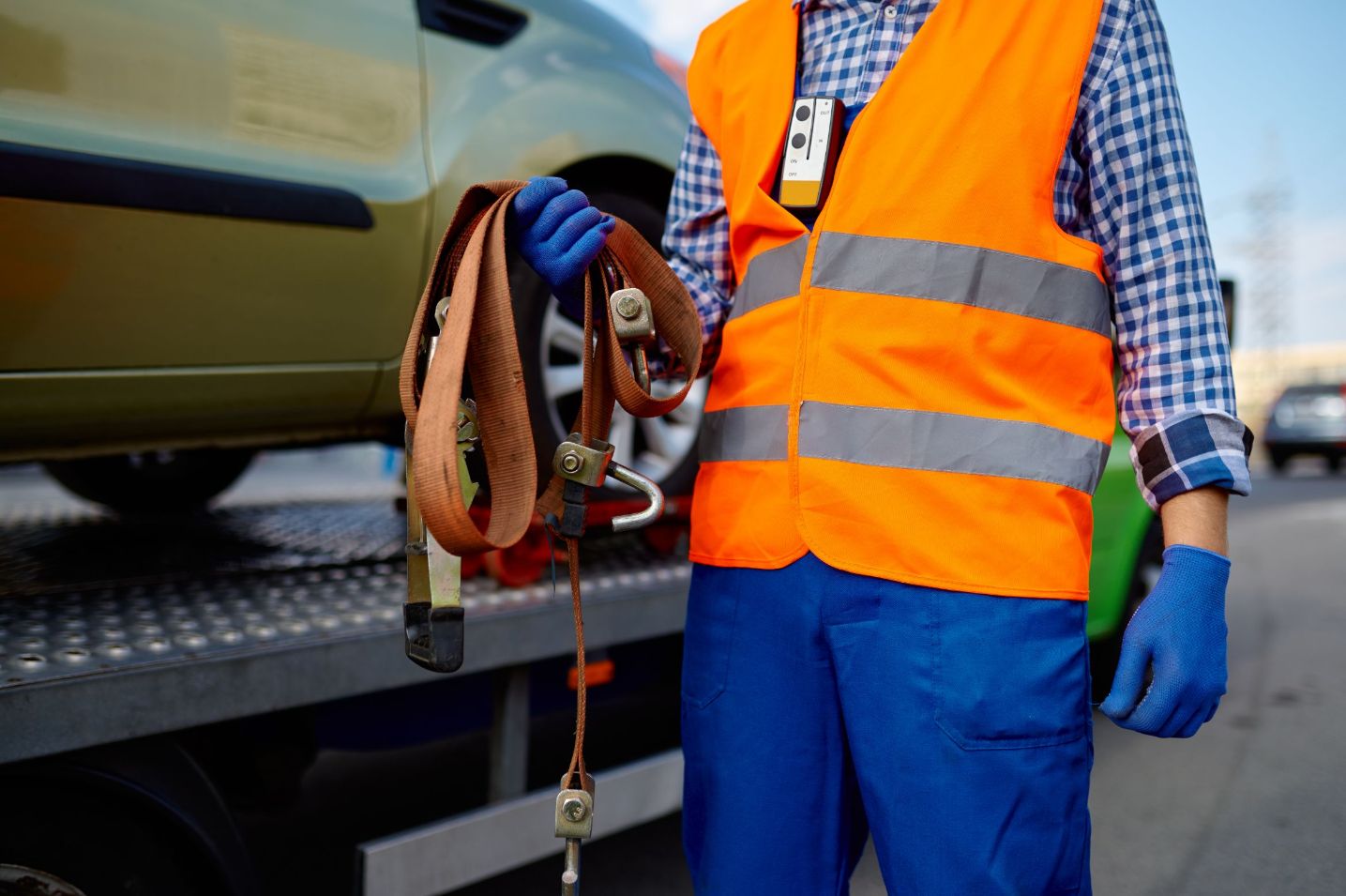 Tow truck driver securing vehicle.